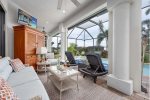 Covered Lanai with TV and Tropical Landscape