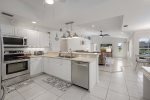 Kitchen with Open Floor Plan Set up And Views to Living Room and Pool Space