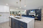 Kitchen with Waterfall Island and View of the Living Room and Dining Room