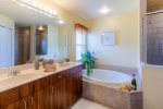 The master bathroom has dual sinks, soaking tub and walk in shower