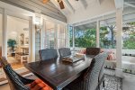 Screened in Porch with a Dining Table and Bench seating
