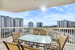 Large balcony with dining table, seating for six, and gulf views