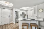 Kitchen with bar seating, granit countertops and stainless steel appliances