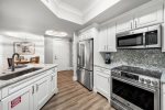 Upgraded kitchen with granite backsplash and stainless steel appliances