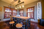 Dining area with unique dining table and lighting.