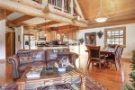 Antler Lodge - Living area with beautiful full log beams.