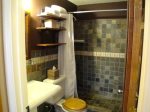 Natural Slate,  Walk In Shower, Pedestal Sink and Plush Towels