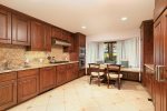 Kitchen features sub-Zero refrigerator and wine cooler, sharp convection microwave oven, Scotsman ice maker, Bosch dishwasher, and trash compactor