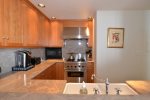 The newly renovated kitchen offers the finest appliances and finishes