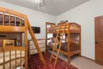 The  downstairs bedroom is equipped with two bunk beds, perfect for accommodating multiple guests