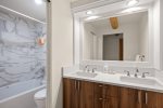 The newly remodeled bath with separate vanity area is located just outside the two guest bedrooms.