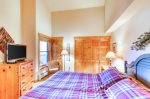 Bedroom with vaulted ceilings, tv, queen bed