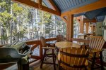 Patio off living room with grill and gorgeous forest views