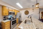 Kitchen with granite countertops and stainless steel appliances