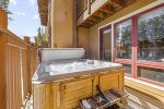 Hot tub on patio with doors to both queen rooms