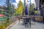 Lovely patio off living room with gas grill and table