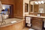 En suite bathrooms with a separate jacuzzi tub and steam shower