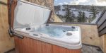 Elevate your leisure time in the private rooftop hot tub, where an outdoor fireplace creates an enchanting ambiance for evening relaxation