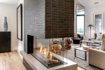 The Gas Fireplace is double sided to be enjoyed in the dining room and living room both.