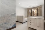 Guest bedroom 2 with twin beds and modern furnishings for a stylish and comfortable stay.