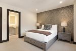 Guest bedroom 3 featuring a queen bed and an en suite bathroom for a comfortable and private retreat.