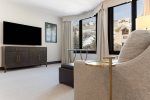 Spacious primary bedroom featuring a king bed and a queen sleeper sofa, perfect for relaxation and accommodating guests.