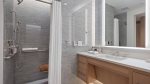 Spacious en suite with a shower, quartz vanity, and luxury bath amenities.