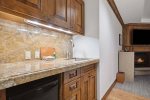 Primary Bedroom with attached bathroom, fireplace, mini bar