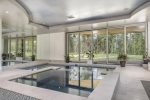 Indoor pool with cascading infinity hot tub, upper patio mountain-view hot tub overlooking a full panorama