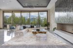 Modern glass-wall fireplace, designer finishes and fixtures everywhere you look and touch, a sprawling chef`s kitchen, enormous lounge/booth