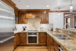 Epicurean kitchen with Viking and Thermador appliances including a gas range and wine refrigerator