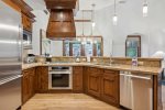 Gourmet kitchen with Viking and Thermador appliances including a gas range and wine refrigerator