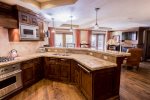 Gourmet kitchen with range, bar seating and stainless steel appliances  
