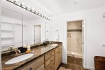 This spacious bathroom found in one of the king bedrooms features a double vanity and separate walk-in shower area.