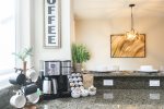 Coffee lovers rejoice This photo features our dedicated coffee bar complete with a 10-cup thermal coffee pot, single K-cup brewer, and a French press. Wake up and smell the coffee in our cozy home away from home. We provide both K-cups and a wonderful se