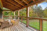Large covered deck off living room is the perfect place to relax on a Summer or fall day