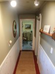 From the kitchen, the hallway leading to the 2 bedrooms.  The Queen bedroom is at the end of the hall