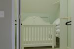 Large Walk-In Closet with Baby Crib and Extra Sheets