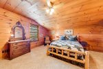 Upstairs bedroom with log frame bed