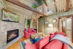 Living area with spiral staircase to loft