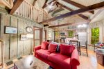 Living area with spiral staircase to loft