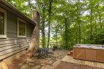 Side of home with hot tub and firepit area