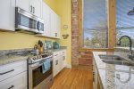 Enjoy Whipping Up Your Favorite Dishes with the Generous Counterspace at this Lovely Loft