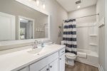 Refresh After Dinner in the Main Level Bathroom, Featuring a Convenient Tub and Shower Combo