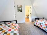 Upstairs bedroom with two twin beds and two trundles  ideal for kids or extra guests.