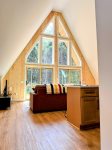 Floor-to-ceiling windows bring the forest right inside.