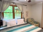 Forest views, soft linens, and a chair made for book lovers, your Wildhaus recharge zone awaits.