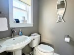 The first-floor half bath is bright, functional, and thoughtfully designed for easy guest access.