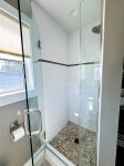 The king suites ensuite features a glass walk-in shower with a pebble-stone floorperfect for rinsing off after the beach or waking up refreshed.