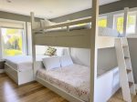 This second-floor bunk room features two queen beds perfect for teens, couples, or anyone who wants a playful space without sacrificing a good nights sleep.